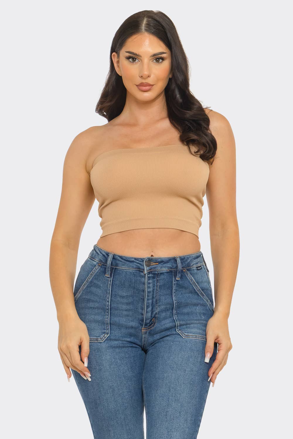 Model wearing a Strapless ribbed bandeau crop top with jeans, showcasing a seamless and stylish look.