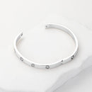 Stylish stainless steel station bangle bracelet close up